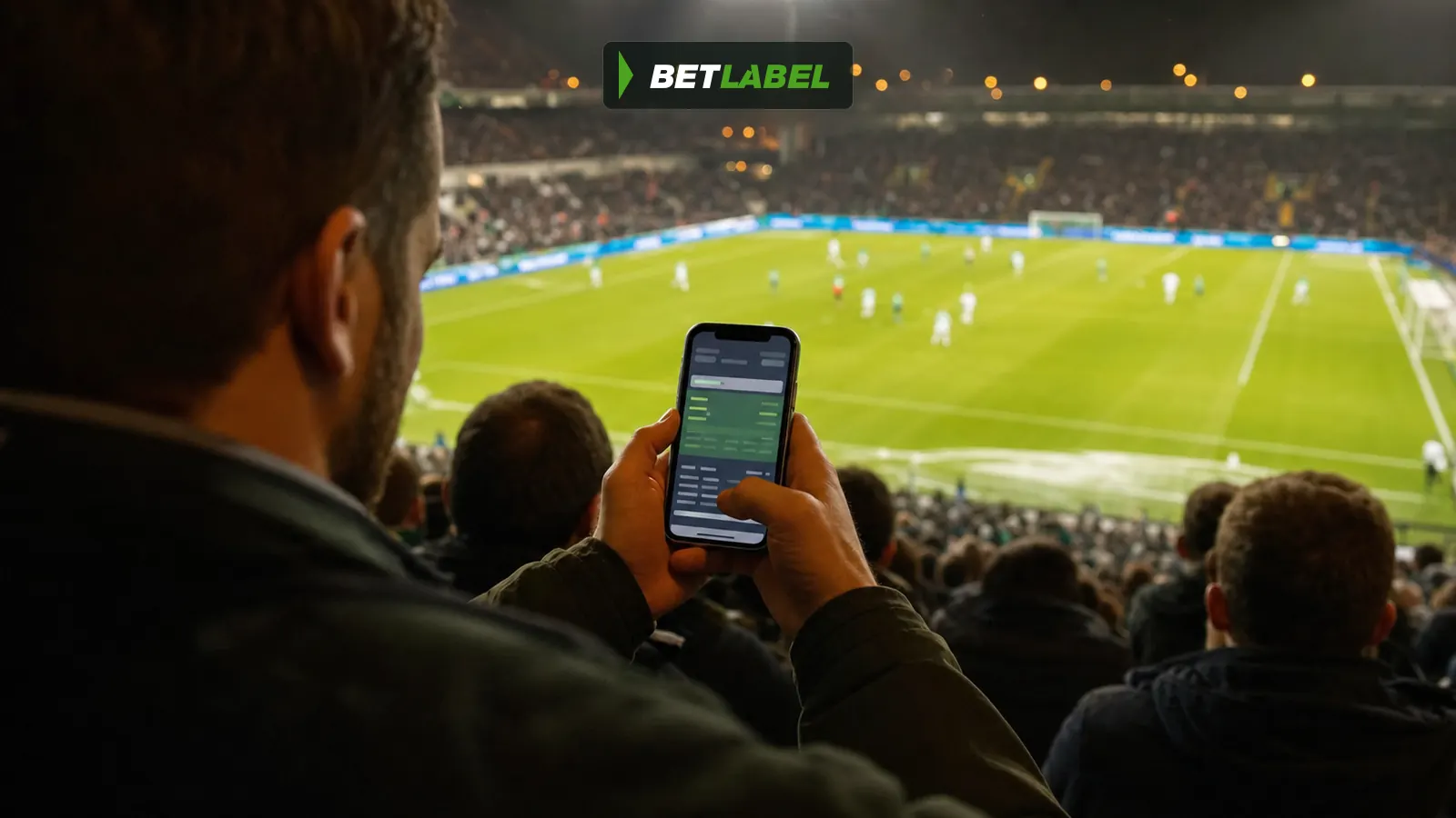 A supporter uses the BetLabel app during a live football match